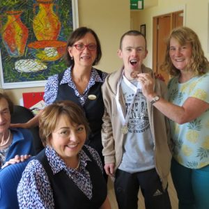 Adrian O’Neill, parish office volunteer, returns from the Special Olympics