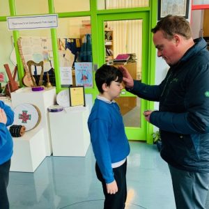 Students of Holy Family School receiving Ashes on Ash Wednesday from Fr. Ger & Fr. Dariusz